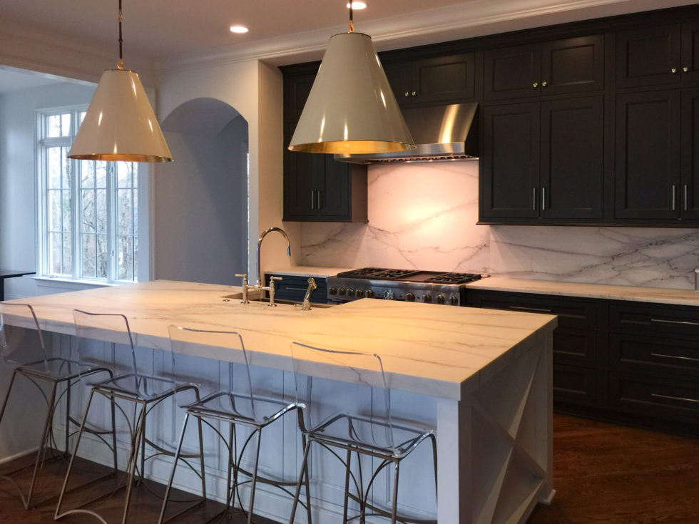 Dark cabinet kitchen with marble countertops