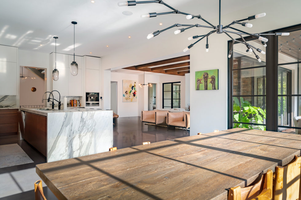 Marble kitchen with chandelier over the island