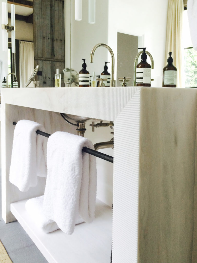 Marble bath vanity with fluted detail