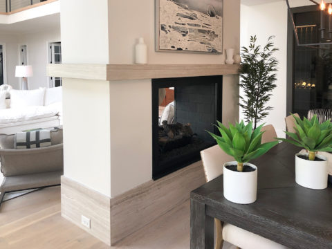 Two sided fireplace clad in a stone column