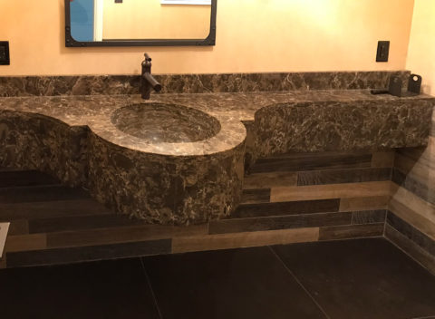 Brown marble double vanity with stone backsplash