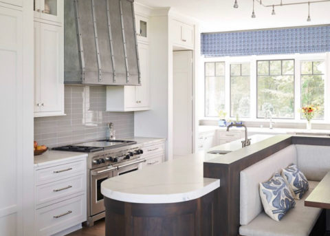 White kitchen with plaster hood and stone island