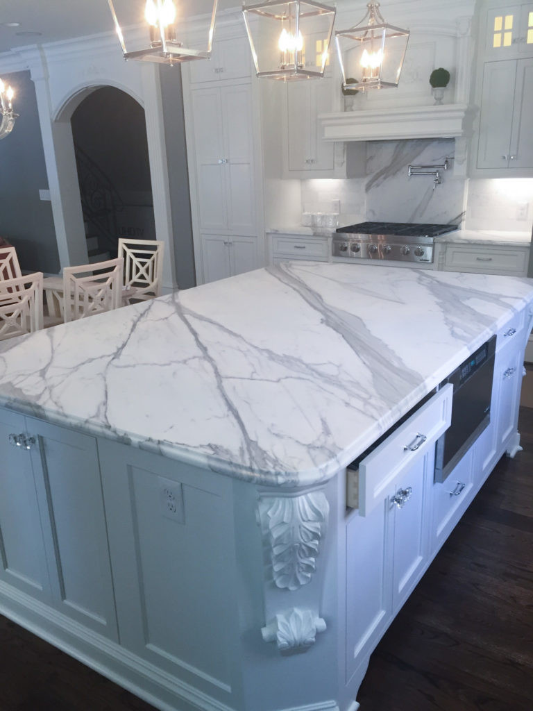 Boldly veined marble island with carved corbel detail