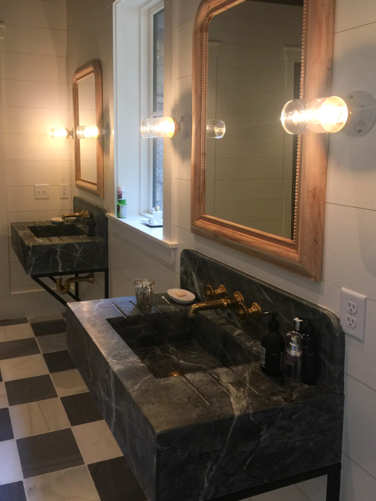 Soapstone vanity above a checkered marble floor