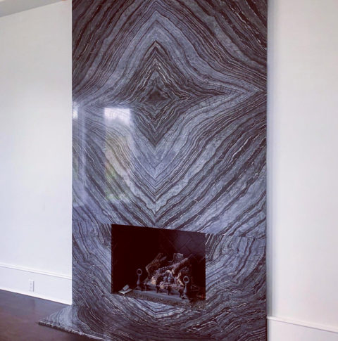 Bookmatched stone fireplace feature wall